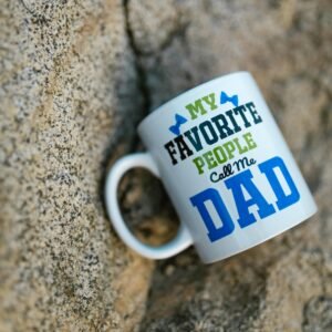 Ceramic mug with 'My Favorite People Call Me Dad' design on a stone background.